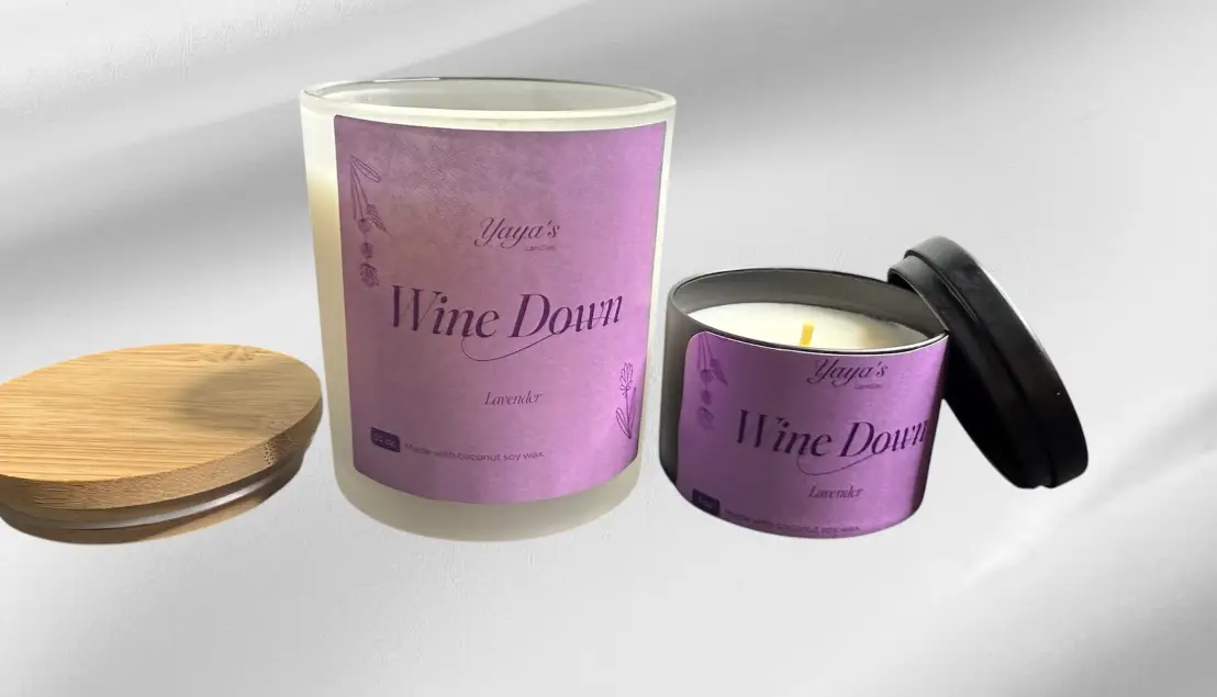 Two lavender-scented candles labeled "Wine Down" by Yaya's, one in a frosted glass jar, the other in a round black tin.